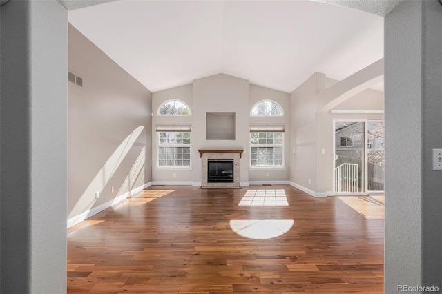 unfurnished living room featuring hardwood / wood-style floors and high vaulted ceiling