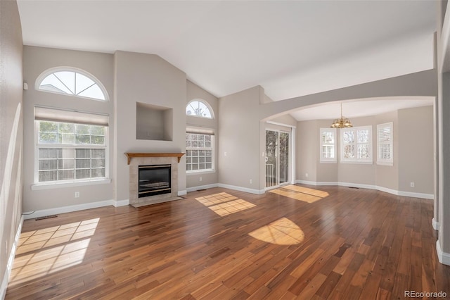 unfurnished living room featuring hardwood / wood-style floors, a healthy amount of sunlight, and a fireplace