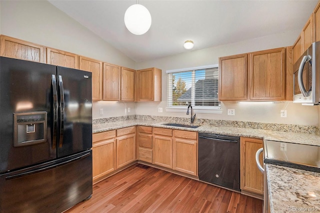 kitchen with light wood-type flooring, black appliances, sink, and lofted ceiling