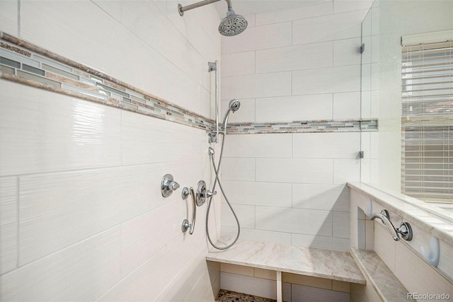 bathroom with a tile shower