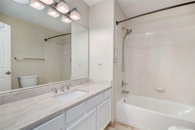 full bathroom featuring vanity, toilet, and tiled shower / bath combo