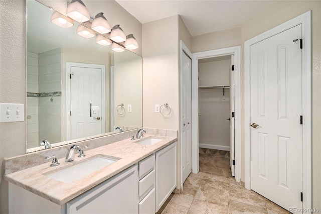 bathroom featuring walk in shower and vanity