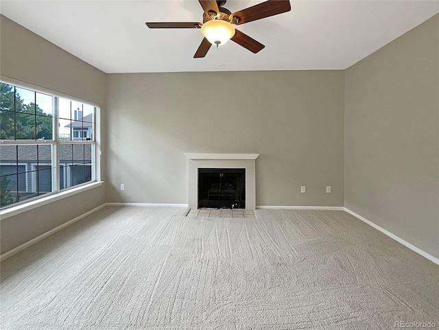 unfurnished living room featuring carpet flooring and ceiling fan