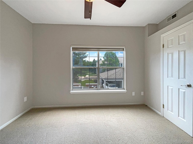 spare room with carpet floors and ceiling fan