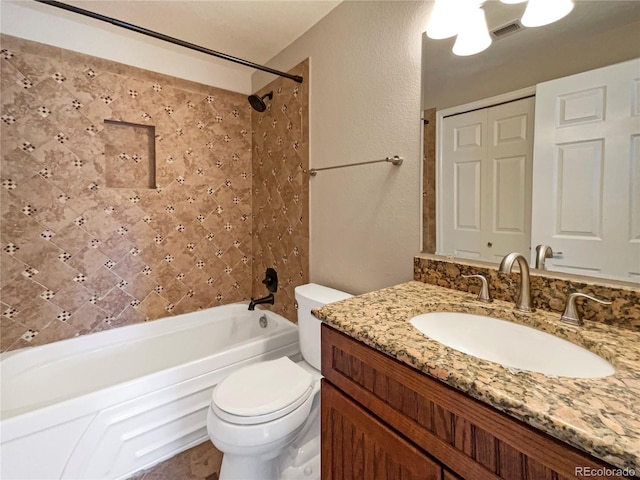 full bathroom with vanity, toilet, and tiled shower / bath combo