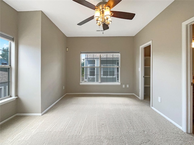 carpeted spare room with ceiling fan