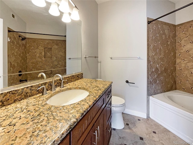 full bathroom featuring vanity, tiled shower / bath combo, and toilet