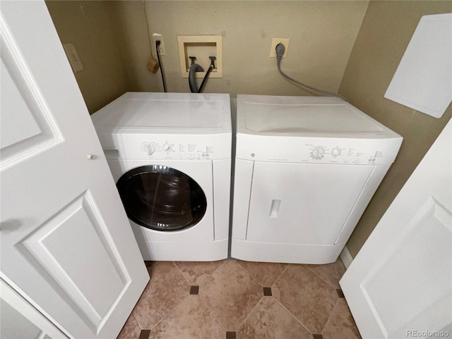 clothes washing area featuring separate washer and dryer and light tile patterned floors