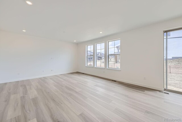 unfurnished room with light hardwood / wood-style floors