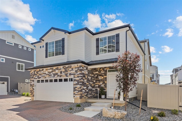 4060 N Rome St, Aurora, CO 80019 - view of front of property with an attached garage, decorative driveway, and stone siding