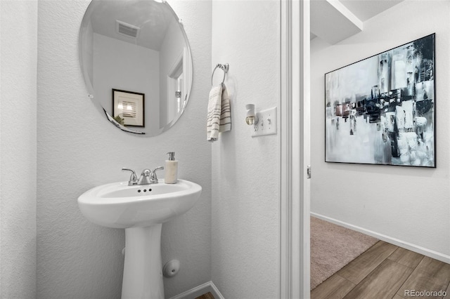 4060 N Rome St, Aurora, CO 80019 - bathroom featuring wood finished floors and baseboards