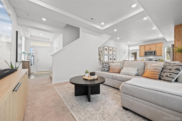 4060 N Rome St, Aurora, CO 80019 - living room with recessed lighting, light colored carpet, a tray ceiling, and baseboards