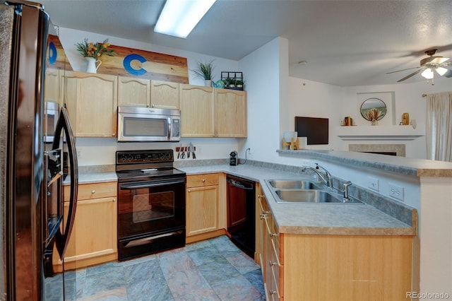 kitchen featuring ceiling fan, light brown cabinetry, a peninsula, black appliances, and a sink