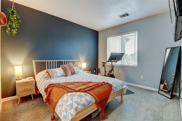 bedroom with carpet flooring, baseboards, and visible vents