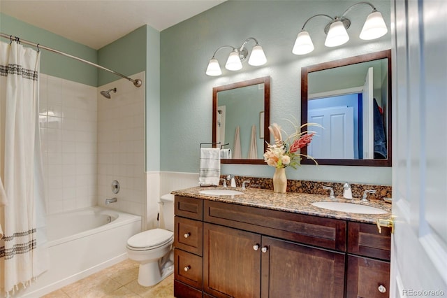 full bathroom featuring shower / bath combination with curtain, toilet, double vanity, and a sink