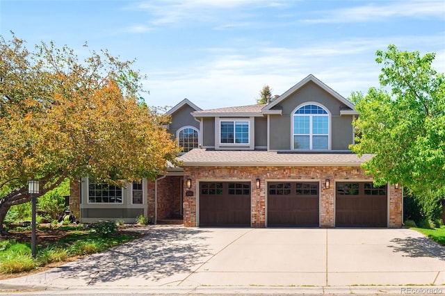 2345 Spotswood Pl, Boulder, CO 80304 - view of front of house with concrete driveway, stucco siding, and an attached garage