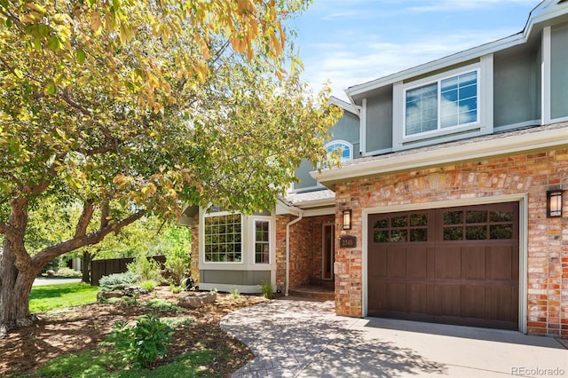 2345 Spotswood Pl, Boulder, CO 80304 - traditional-style home featuring an attached garage, brick siding, and concrete driveway