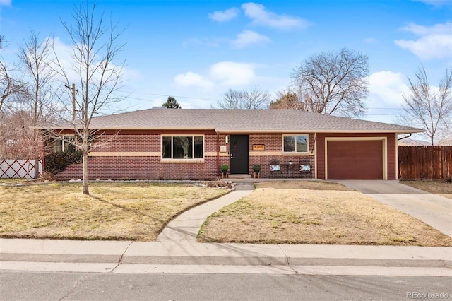 ranch-style home with a front lawn, driveway, fence, an attached garage, and brick siding