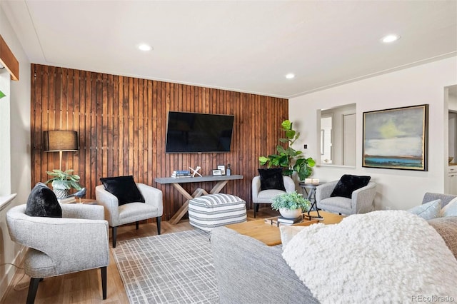 living room featuring wooden walls, recessed lighting, and wood finished floors