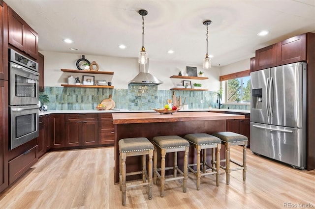 kitchen with open shelves, wall chimney exhaust hood, tasteful backsplash, and stainless steel appliances