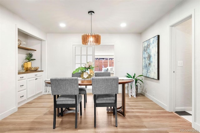 dining area featuring a chandelier, recessed lighting, baseboards, and light wood-style floors