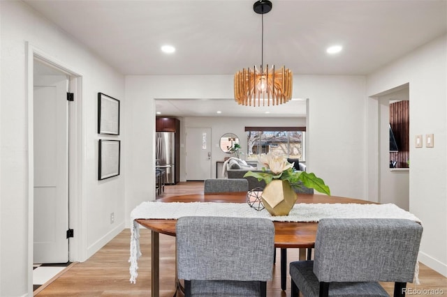 dining room featuring recessed lighting, a notable chandelier, and light wood finished floors