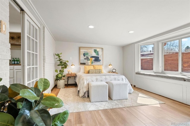 bedroom with recessed lighting and light wood-type flooring