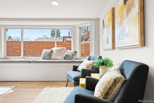 sitting room with recessed lighting, plenty of natural light, and wood finished floors