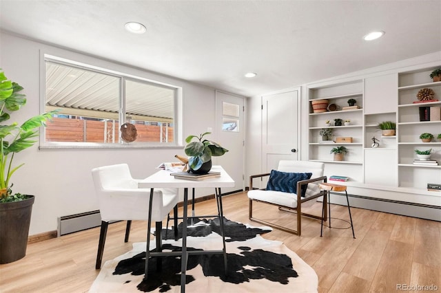 living area featuring recessed lighting, baseboard heating, and light wood finished floors