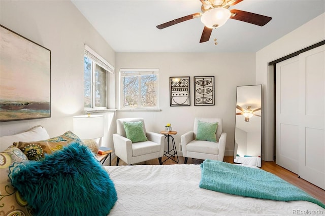 bedroom featuring ceiling fan, a closet, and wood finished floors