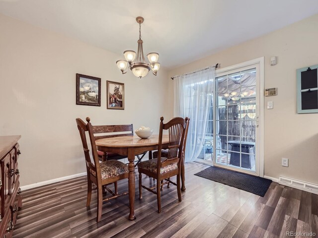 dining room featuring dark wood-type flooring and a chandelier