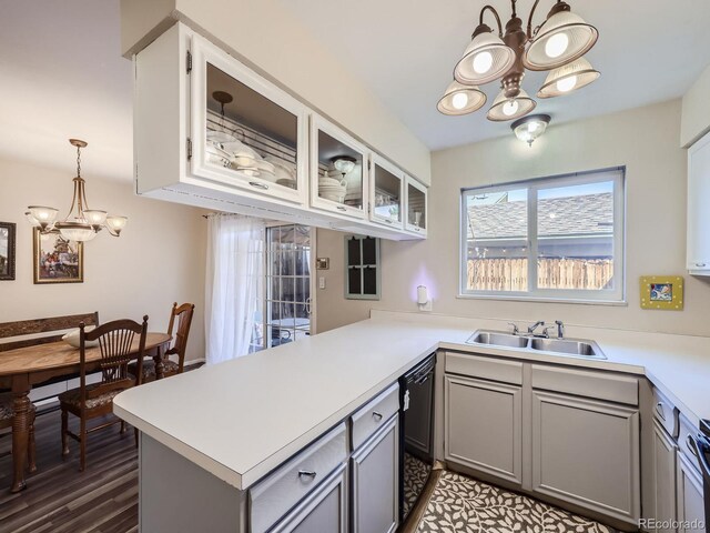 kitchen with pendant lighting, a chandelier, kitchen peninsula, and gray cabinetry