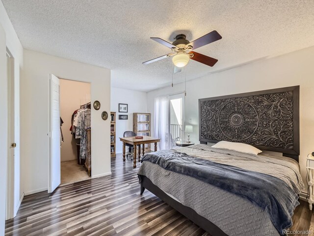 bedroom featuring a textured ceiling, dark hardwood / wood-style floors, and a closet