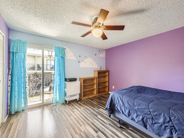 bedroom with a textured ceiling, ceiling fan, and multiple windows