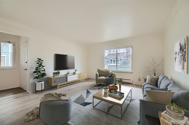 living area with plenty of natural light, a baseboard radiator, and wood finished floors