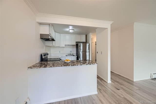 kitchen with ornamental molding, a peninsula, under cabinet range hood, dark stone counters, and stainless steel appliances