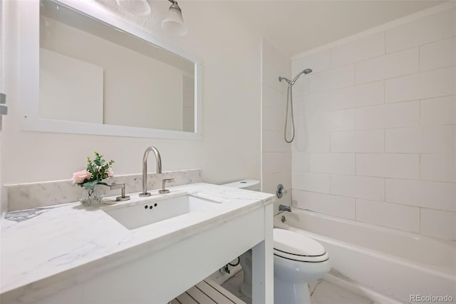 full bath with toilet, marble finish floor, shower / bathing tub combination, and vanity