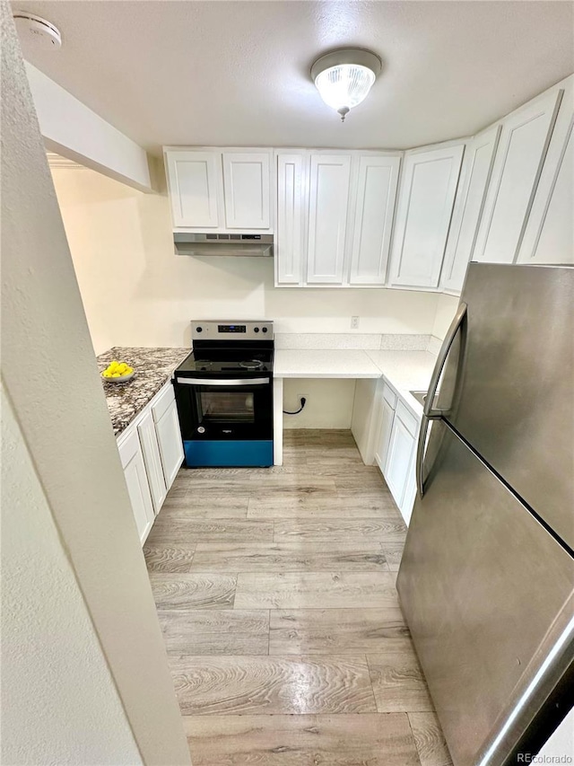 kitchen featuring white cabinets, electric range oven, freestanding refrigerator, under cabinet range hood, and light wood finished floors