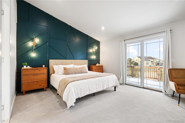 bedroom with light carpet, vaulted ceiling, and access to outside