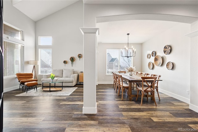 dining area featuring arched walkways, dark wood finished floors, baseboards, and an inviting chandelier