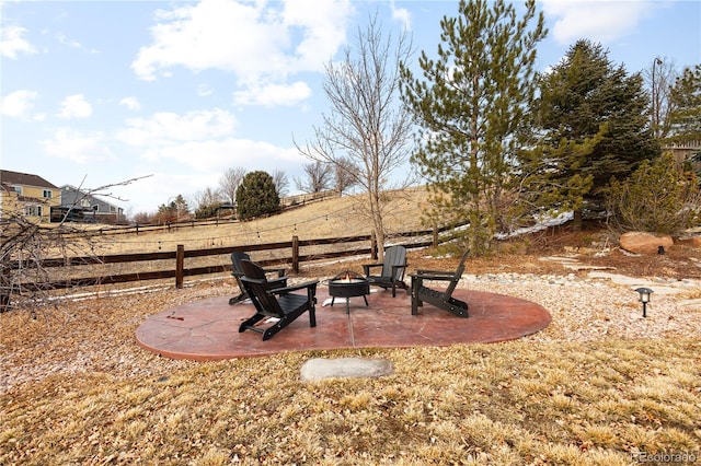 view of yard featuring fence, a fire pit, and a patio