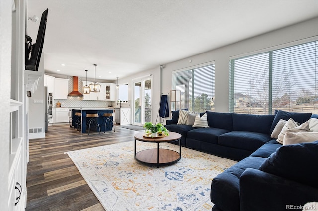 living room featuring dark wood-type flooring, visible vents, and recessed lighting