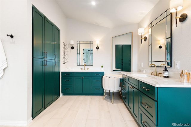 bathroom with two vanities, lofted ceiling, and a sink