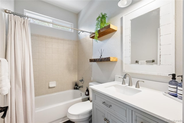 full bath featuring a textured wall, shower / bath combination with curtain, vanity, and toilet