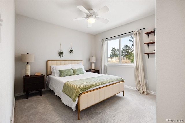 carpeted bedroom with a ceiling fan and baseboards