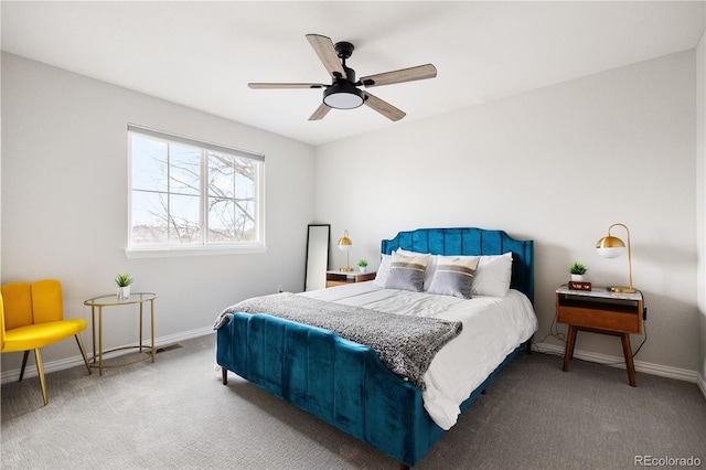 bedroom with a ceiling fan, baseboards, and carpet flooring