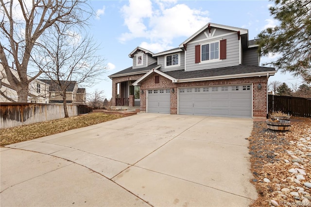 craftsman inspired home with driveway, covered porch, an attached garage, fence, and brick siding