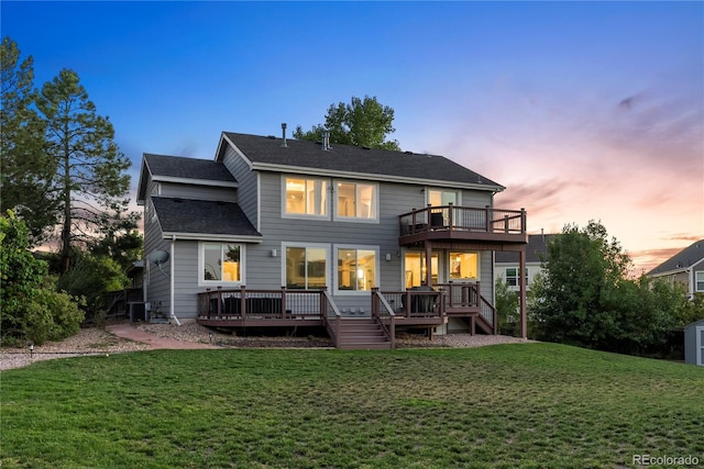 10039 Heatherwood Pl, Highlands Ranch, CO 80126 - back of house at dusk featuring a yard, cooling unit, a wooden deck, and a shingled roof