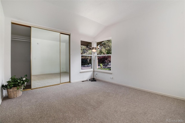 8543 Redstone St, Highlands Ranch, CO 80126 - unfurnished bedroom featuring carpet, lofted ceiling, and a closet