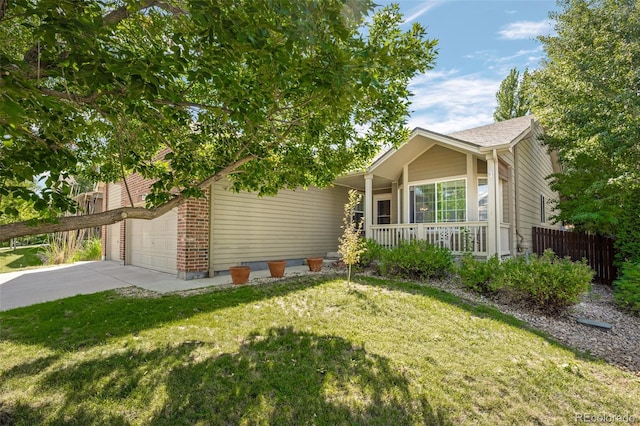 view of front of home featuring driveway, a garage, fence, a front yard, and brick siding